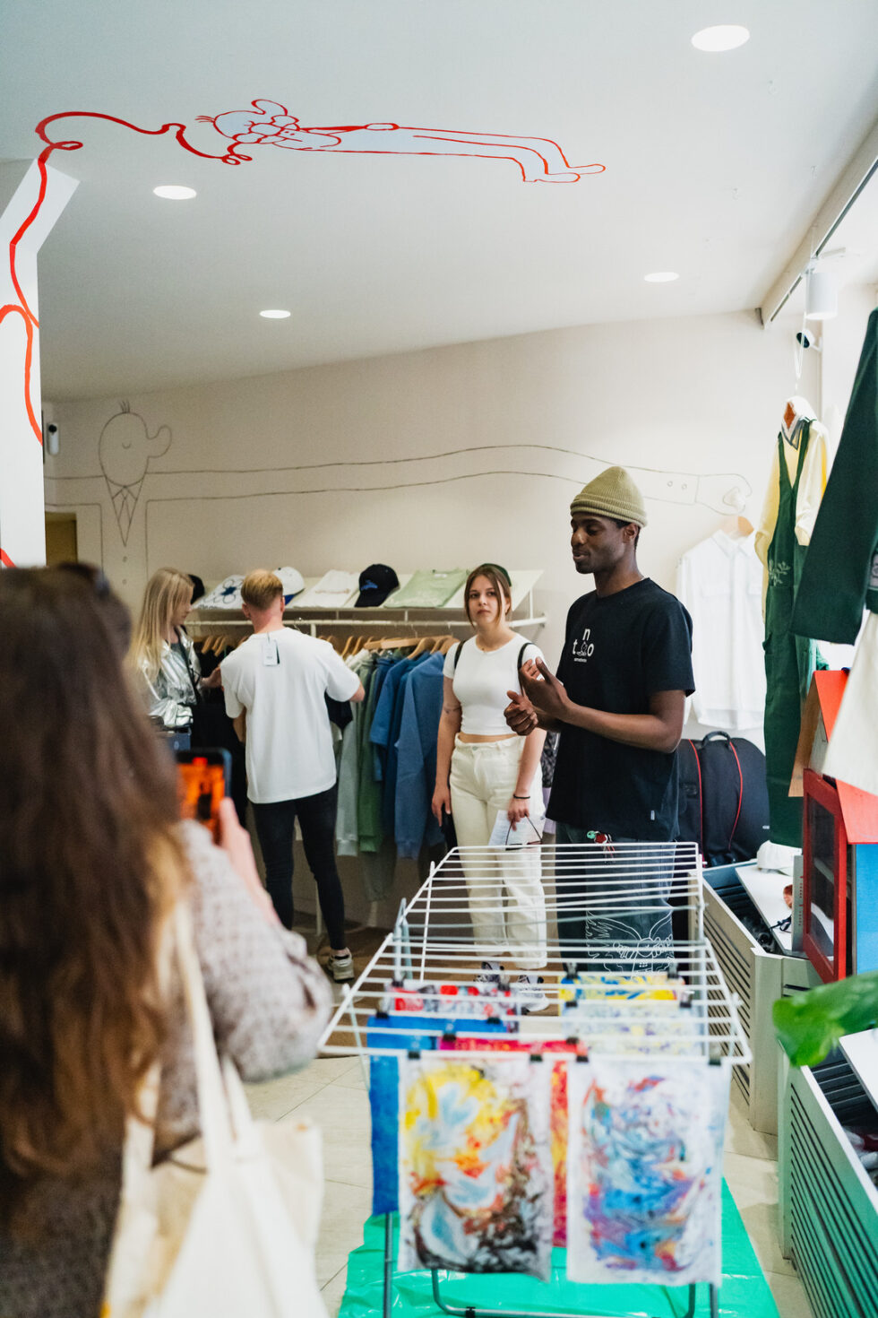 Group of people in a clothing store, man giving a presentation