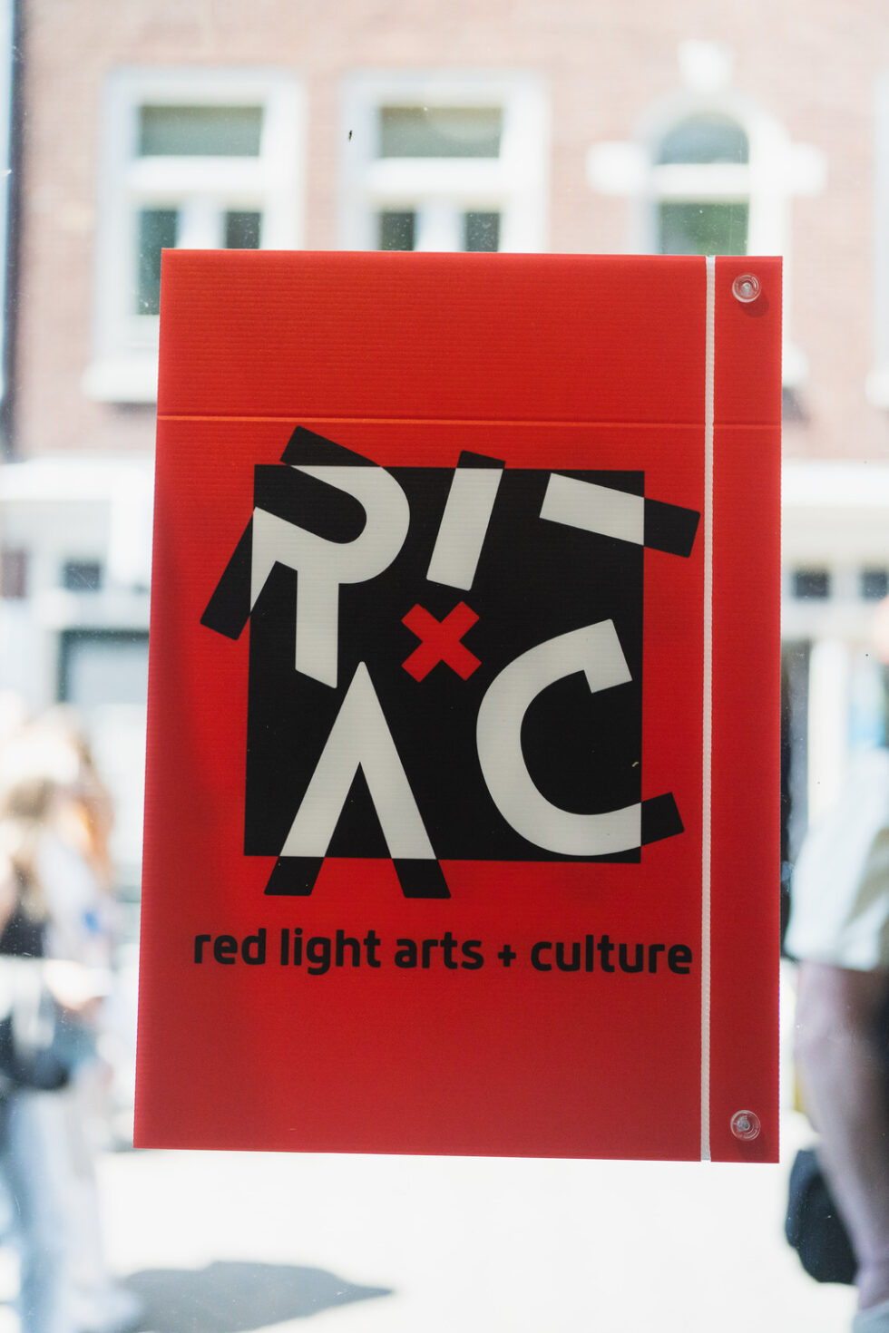 Red Light Arts + Culture sign on a window.