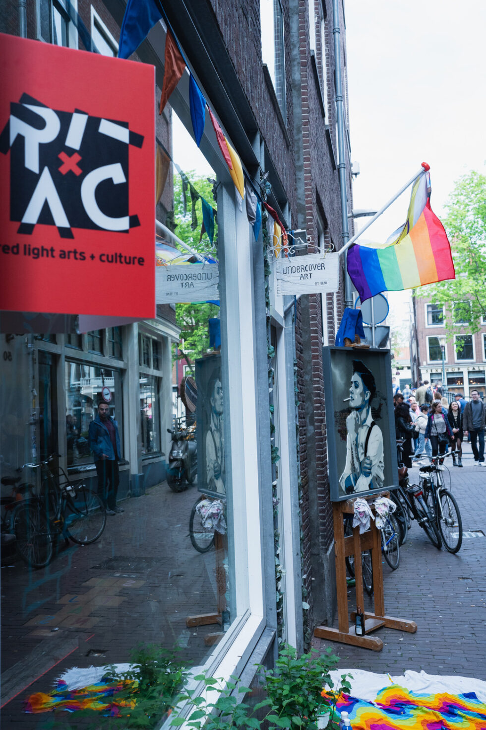 Red Light Arts + Culture gallery with rainbow flag and art display in Amsterdam.